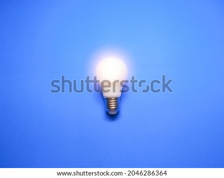 Idea concept. Lightbulb isolated with blue background.