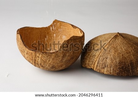 Coconut shell isolated on white background. The coconut flakes are removed from the inside of the coconut shell.