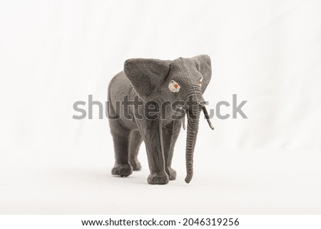 Plastic toy elephant on white background..