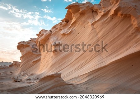 Wavy structures of sedimentary rocks at Abu Dhabi, UAE. Best destinations Royalty-Free Stock Photo #2046320969