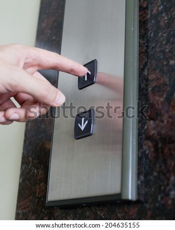 Men pushing elevator button.