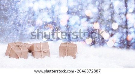 christmas presents and fir in the snow with bokeh and copy space