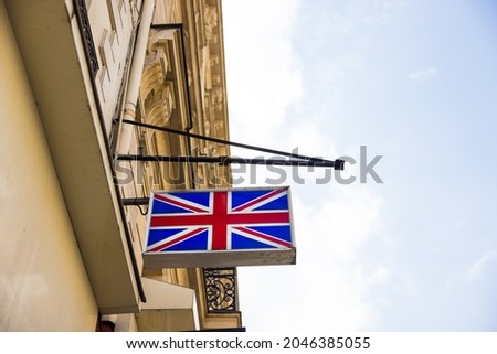 A low angle shot of a hanging United Kingdom flag banner on a building