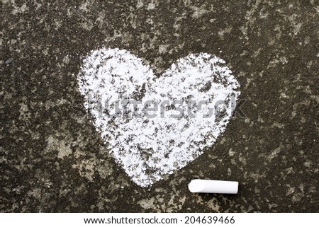 white heart drawn in chalk on concrete