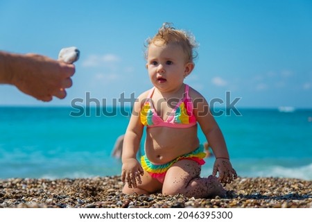 Child girl at the sea. Selective focus. Baby.