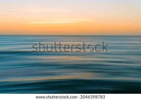 Sunset seascape abstract in bright blue, cyan, yellow colors, motion blur, copy space
