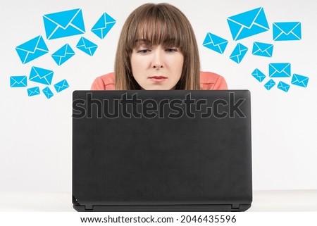 Email concept. Electronic correspondence. Woman writes and reads e-mails. Girl reads letters on a laptop. The woman looks at the laptop screen. Icons with letters around it. Collage of electronic mail