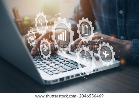 Person working on computer with icons of planning schedule. budget, team work, scope, risks, strategy, with gears Professional project manager presenting management skills concept.  Royalty-Free Stock Photo #2046556469