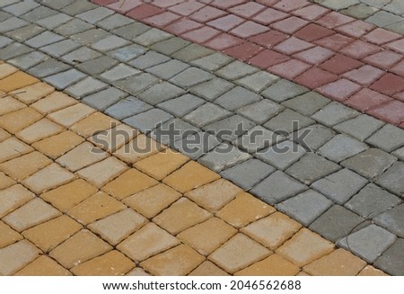 Close-up of tessellated concrete slabs texture. Tiled pavement paving in square shape. Tileable cement or tile mosaic. Construction road and sidewalk, textured  background.