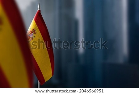 Small flags of Spain on a blurry background of the city Royalty-Free Stock Photo #2046566951