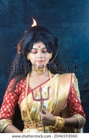 Bengali Married women performing dhunuchi dance on the occasion of durga puja with sari and gold jewelry