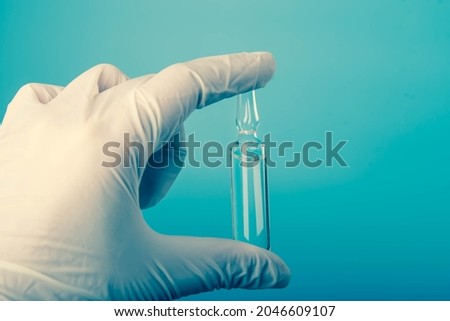 Doctor's hands in gloves are holding the vaccine. Delta virus. Health care and medical concept.