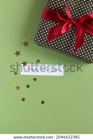 Christmas flat lay composition. Christmas decorations and gift boxes on pastel green background.