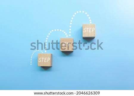 step by step letters on wooden cube.growth concept