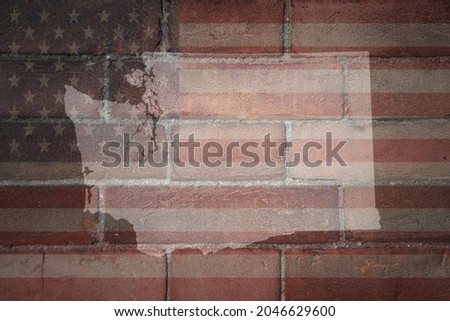 map of washington state on a painted flag of united states of america on a old brick wall