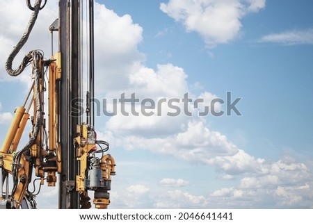 Powerful hydraulic drilling rig on a construction site. Installation of bored piles by drilling. Pile foundations. Drilling in the ground Royalty-Free Stock Photo #2046641441