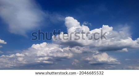 Wonderful landscape of white fluffy clouds on the blue sky.