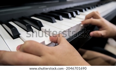 Close-up of a child's hand playing the piano . Favorite classical music. musical instruments for teaching music at home. The concept of a musical instrument. Self-education