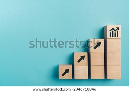 Sale volume increase make business grow , Business growth concept , wood block stacking as step stair on paper blue background, copy space. Royalty-Free Stock Photo #2046718046