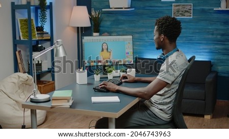 African american photographer doing editing work on pictures. Black man working with retouch software on computer for photography production. Media editor retouching photos with app