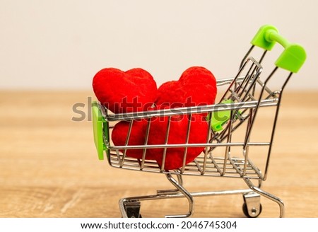 Red hearts in the supermarket cart. It’s full with love and full fill sweet moment for couple is love each other. Next step is wedding and live forever.