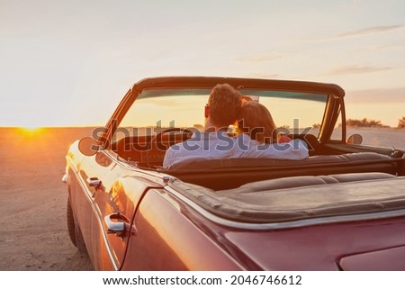luxury, romantic couple in vintage classic cabriolet car at sunset Royalty-Free Stock Photo #2046746612