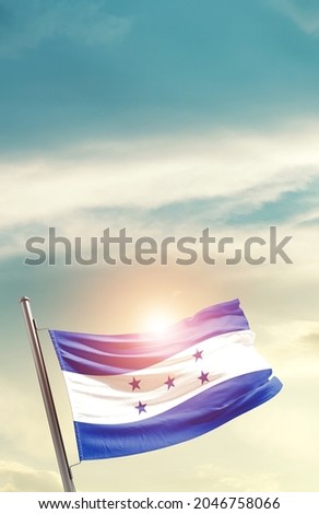 Honduras national flag waving in beautiful clouds.