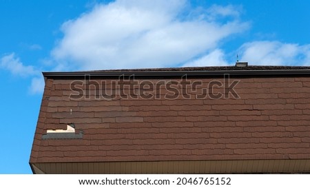 A badly damaged shingles roof