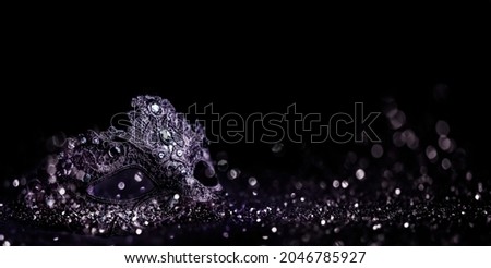 
Luxury venetian mask on dark silver bokeh background. New year eve and christmas party celebration design banner. Fantasy carneval masquerade event costume. Royalty-Free Stock Photo #2046785927