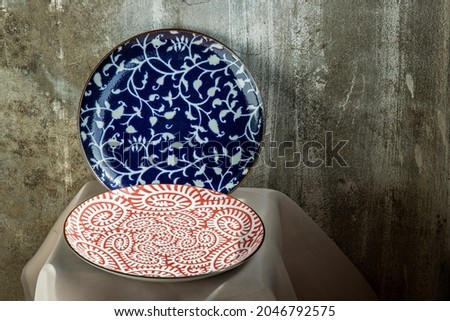 Two ceramics plates on pink table cloth. Ceramic tableware, Beautiful arrangement, Copy space,  Selective focus.