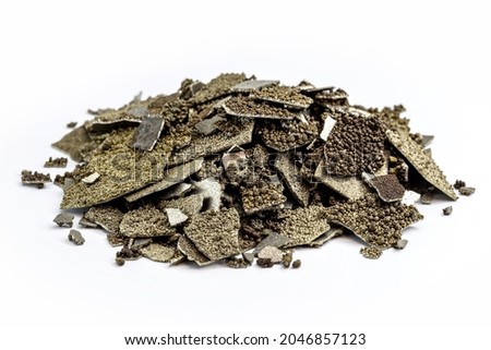 Manganese samples, flaked pure manganese metal used in industry, isolated white background. Royalty-Free Stock Photo #2046857123