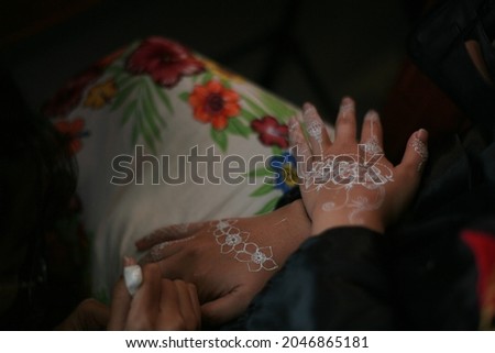 the woman's hand that was hennaed before the wedding ceremony started