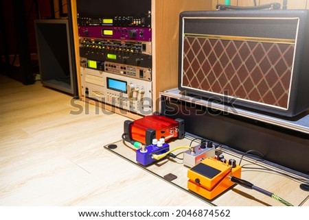 guitar pedal effect processor, amplifer, sound module and sampler in home recording studio. music background Royalty-Free Stock Photo #2046874562