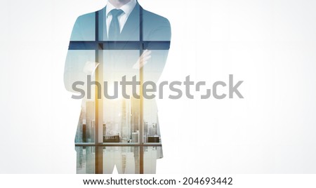 Double exposure of businessman and city 