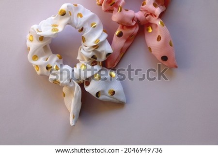 Two polka dot scrunchies on pastel background. Flat lay.