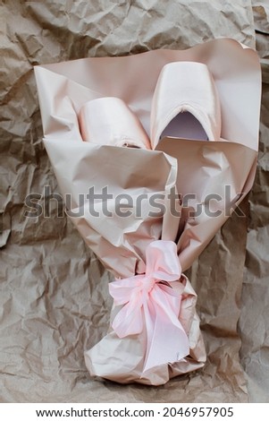 New ballet shoes, pointe shoes lie on a light background. Dancing as an art form