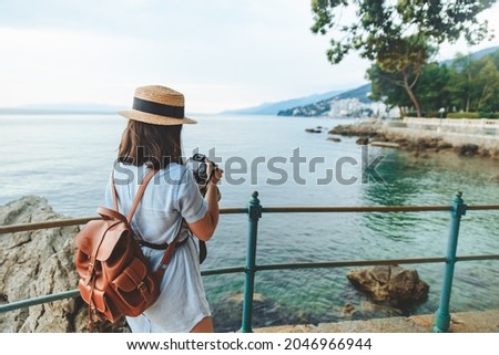 woman taking picture on big camera sea summer vacation copy space