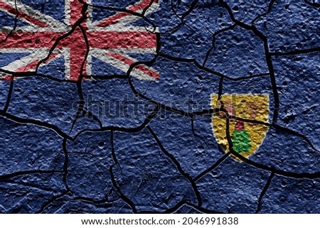 Turks and Caicos Islands flag on a mud texture of dry crack on the ground