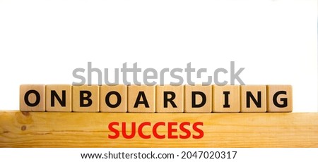 Onboarding success symbol. Words 'Onboarding success' on wooden cubes. Business and onboarding success concept. Beautiful wooden table, white background. Copy space.