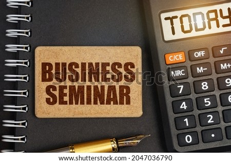 Business concept. On the notebook there is a calculator with the inscription Today and a sign with the inscription - BUSINESS SEMINAR