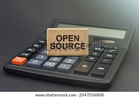 Business concept. There is a sign on the calculator that says - Open Source