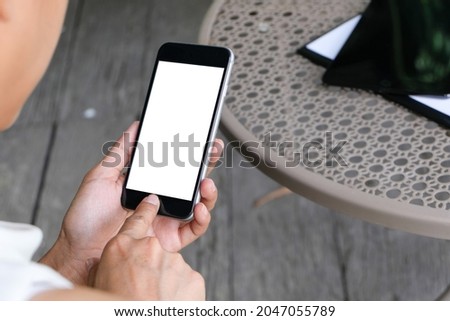 Businessman showing blank business card and holding smart phone.
Business man holding white blank card space for text. product display montage.