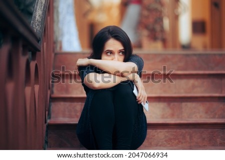 Sad Woman Attending a Party Sitting Alone on the Stairs. Upset girlfriend being stood up waiting on the staircase 
 Royalty-Free Stock Photo #2047066934