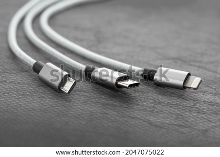 Three types of peripheral connections and charging  or data cables. Concept EU rules to change universal charge plug to USB C Royalty-Free Stock Photo #2047075022