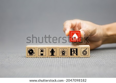 Fire prevention, Cube wooden toy block stack with prevent icon with door exit sing or fire escape with fire extinguisher and emergency protection symbol for safety and rescue in the building. Royalty-Free Stock Photo #2047098182