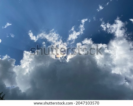 Sunburst visible from behind a dark cloud.