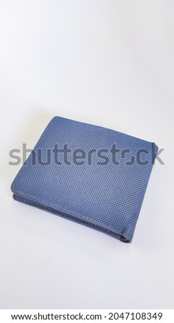 Abstract defocused Photo of a faded blue wallet isolated on a white background