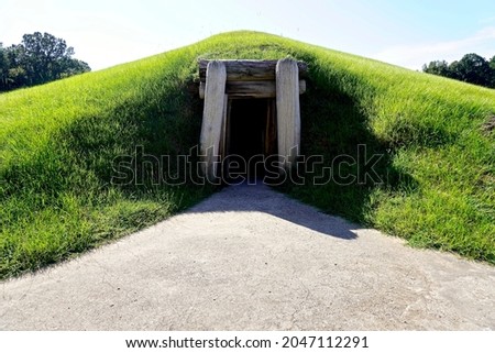 Ocmulgee Mounds National Historical Park in Macon, Georgia preserves  earthworks built by South Appalachian Mississippian culture. Entrance to circular earth lodge built for meetings and ceremonies. Royalty-Free Stock Photo #2047112291
