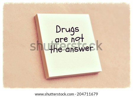 Text drugs are not the answer on the short note texture background