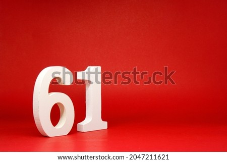 Sixty One ( 61 ) white number wooden Isolated Red Background with Copy Space - New promotion 61% Percentage   Business finance or birthday Concept - advertise banner picture online with copy space